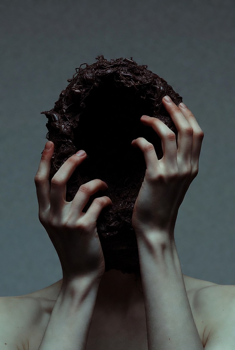 A photograph of hands interacting with a mysterious dark entity, evoking surreal introspection.