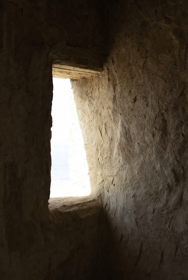 A photograph of a window and wall symbolizing a prophet, with light and shadow representing humility.